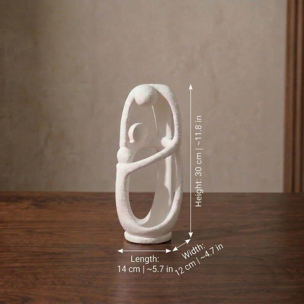 A white abstract Decoava Infinite family sculpture on a wooden table. Graphic arrows indicate its dimensions: Height 30 cm (11.8 in), Length 14 cm (5.7 in), and Width 12 cm (4.7 in).