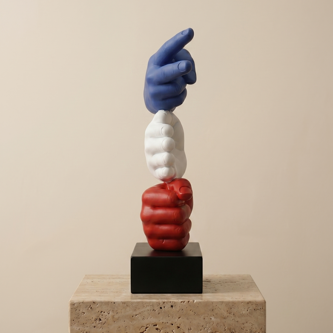 Three-dimensional sculpture of interlocking hands in blue, white, and red on a beige background