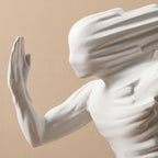 Close-up of a classical statue with a beige background